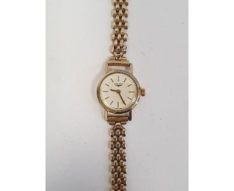 Lady's Longines wristwatch with gold coloured case, baton numerals and side button and the 9ct gold chain link bracelet
