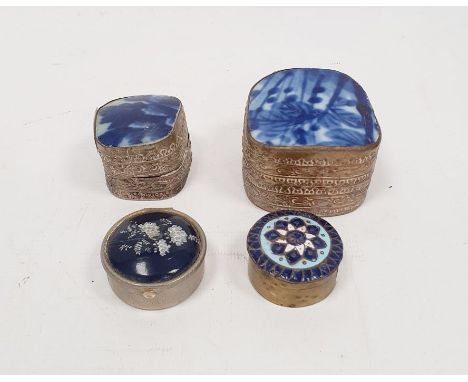 Two Oriental silver-coloured trinket boxes&nbsp;with white ceramic insert to lid, repousse decorated, 5.5cm and 4.5cm wide an
