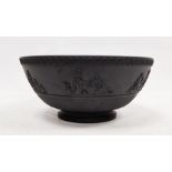 Black basalt bowl in the manner of Wedgwood with decorated rim, the body with applied moulded scenes