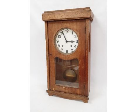 A substantial industrial style wall clock in oak veneered case, plain white painted dial with clear painted arabic numerals. 