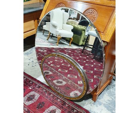 Large circular bevelled plate wall mirror and a smaller oval mirror with paper label to back 'Dodds of Slough' (2)Condition R