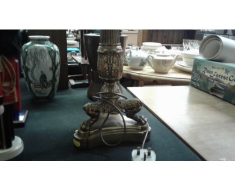 An ornate brass table lamp and shade