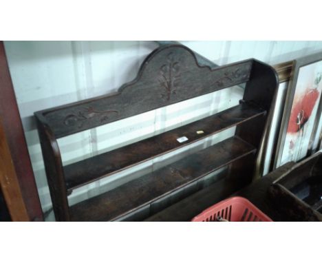 A late Victorian carved oak open book shelf