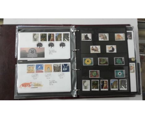 Four albums of first day covers and stamps
