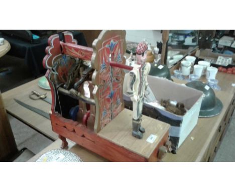 A painted wooden mechanical puppet
