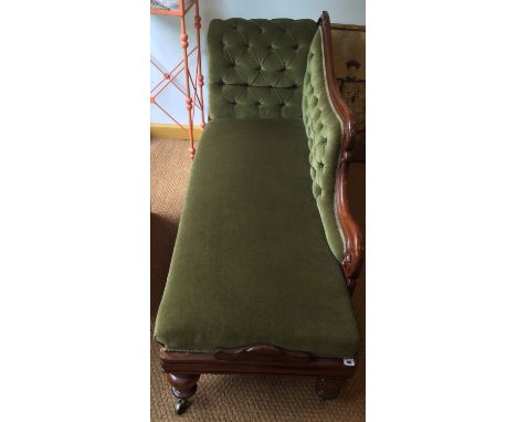 A Victorian mahogany Chaise with button back velvet velour with carved back above bulbous turned supports on castors (one cas