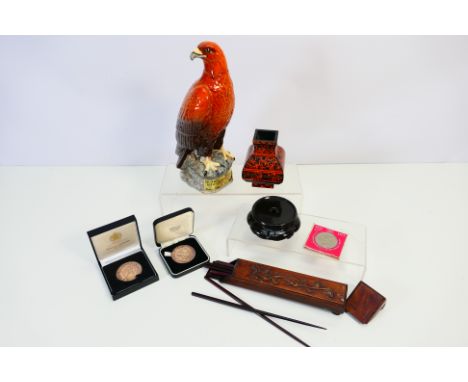 Lot to include a Beswick Golden Eagle decanter (no contents), small quantity of coins and medallions, a small ceramic stand a