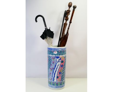 A ceramic stick stand containing walking sticks, a Kendall silk parasol with silver mounted handle and other. [W]
ALL ITEMS M