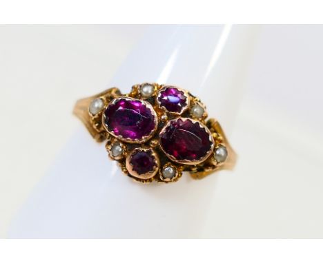 A lady's vintage yellow metal ring stamped 9ct, set with garnets and seed pearls, size S, approx weight 3.20 gm (all in)
ALL 