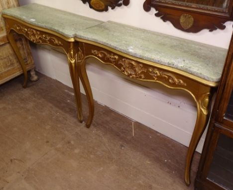 A pair of Continental giltwood console tables, of serpentine form, with shaped marble tops, applied moulded decoration, on ca