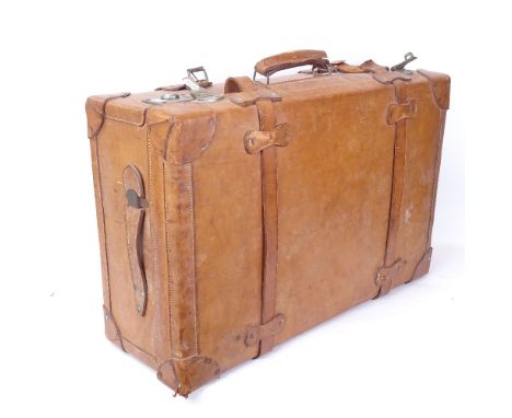 A large leather-bound Vintage travelling suitcase, with fastening straps and carrying handles, length 65cm 