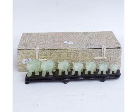 A modern set of carved and polished jade elephants, on fitted display stand with original box 