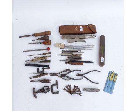 Various watchmaker and craft tools, including levels and G-clamps 