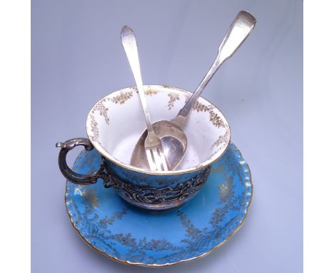 An Edwardian Staffordshire coffee cup and saucer, in  a stylised scrolled and pierced silver stand, hallmarks for London 1906