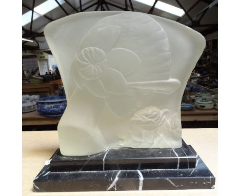 An Art Deco moulded glass portrait of a girl and flower, on stepped marble plinth, height 25cm 