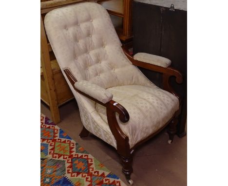 A William IV mahogany open armchair, with button-back upholstery on turned legs 