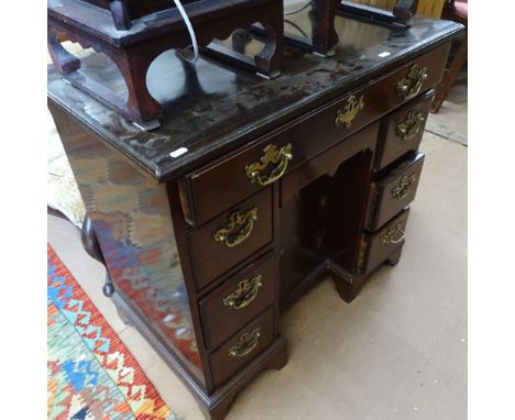 An Antique Queen Anne style knee-hole mahogany writing desk, with 1 long and 3 short drawers, recessed cupboard, on bracket f