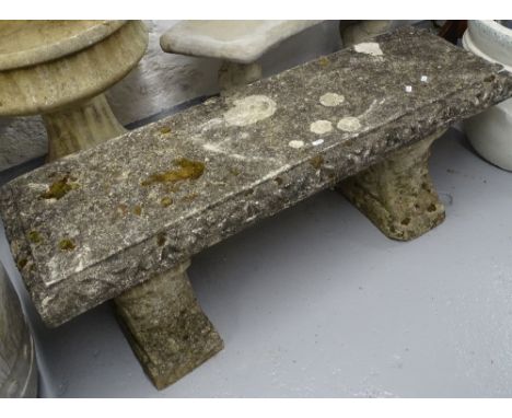 A weathered rectangular concrete garden bench, L117cm 