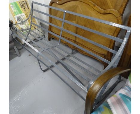 An Antique scrolled wrought-iron garden bench, recently repainted, L182cm 