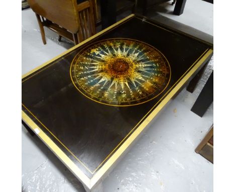 A modern brass-framed glass-top coffee table, with inset compass decoration, L102cm 