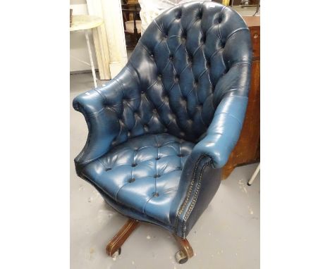 A button-back blue leather-upholstered swivel armchair 