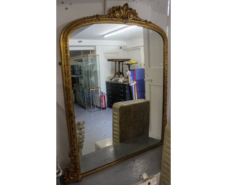 An Antique carved gilt-framed and gesso arch-top over mantel mirror, with acanthus leaf pediment, W120cm, H136cm 