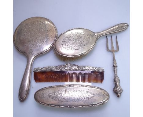 A 3-piece silver-backed dressing table brush and mirror set, a silver-handled toasting fork, and a silver-mounted cone 