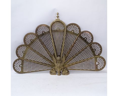 A Victorian brass peacock fire screen, overall height 62cm 