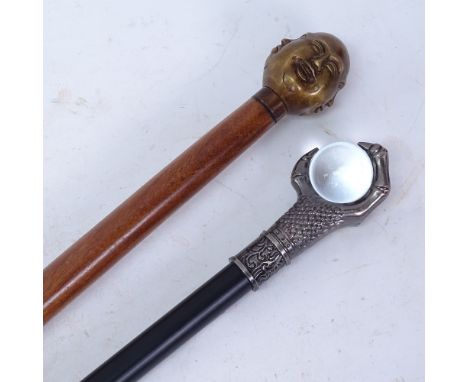 A brass Buddha head hardwood walking cane, and a modern crystal ball knop sword stick (lacking blade) (2) 