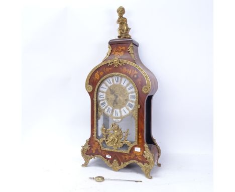 A large reproduction Louis XIV style mantel clock, ornate marquetry inlay with brass mounts, with movement striking on a gong
