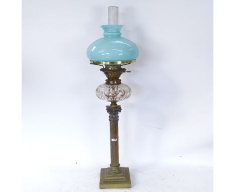 A 19th century brass Corinthian column oil lamp with blue glass shade and cut-glass font, overall height 80cm 