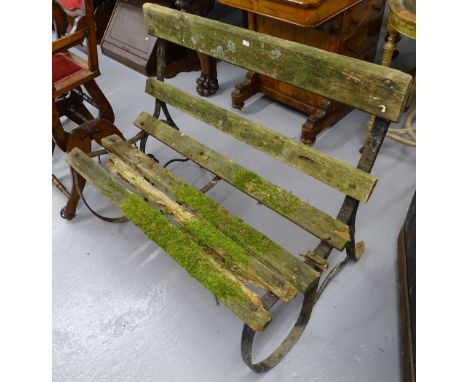 A Victorian scrolled wrought-iron garden bench with slatted seat, W100cm 