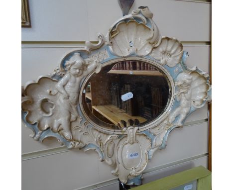 A French mirror with ceramic frame with moulded shells and cupids, length 44cm 