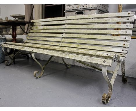 A scrolled wrought-iron and slatted garden bench, L180cm 