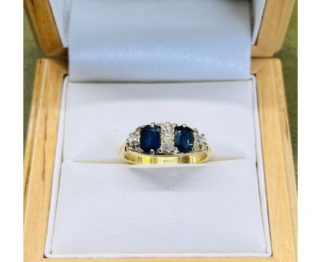 A sapphire and diamond ring, set in 18ct yellow gold, size K.