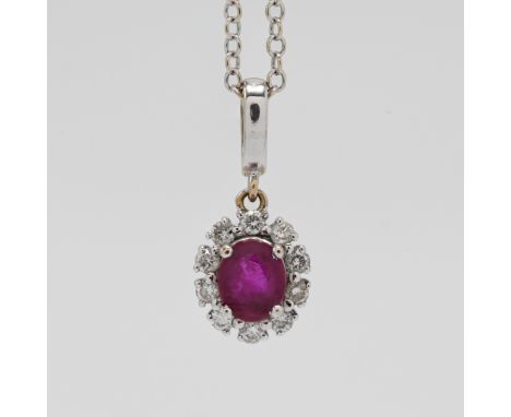 An 18ct white gold ruby and diamond pendant on chain.