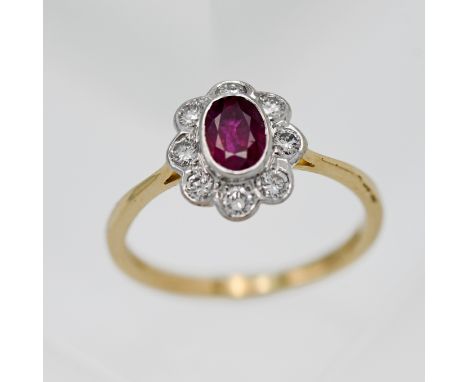 An 18ct yellow gold ruby and diamond cluster ring, size L.