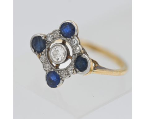 An 18ct gold fancy diamond and sapphire ring set with nine round brilliant cut diamonds and four cut sapphires, weight 2.90g,