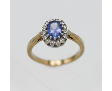 A 9k yellow gold tanzanite and diamond cluster ring, size K/L.