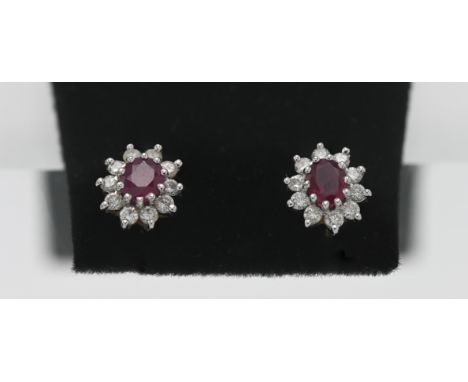 A pair of 18ct gold diamond and ruby studs.