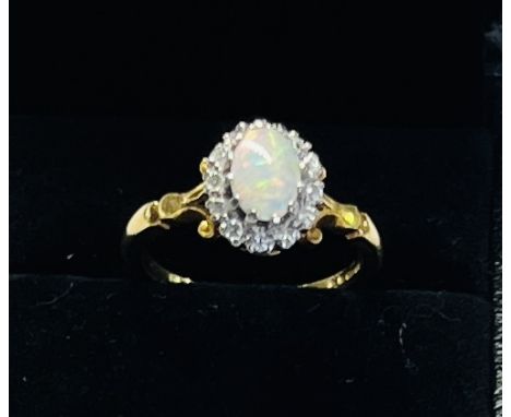 An 18ct opal and diamond cluster ring, size M