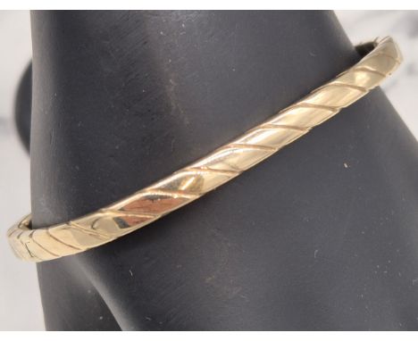 9ct yellow gold twist design bangle. [7.44grams] 