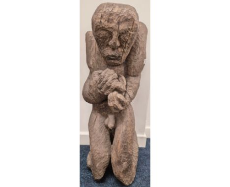 Large Antique hand carved sculpture of a nude man, clutching item within his hands. Possibly African Origin. [83cm high]
