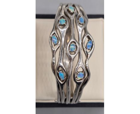 Unusual designed Silver 925 bangle fitted with various sized opal gem stones. 