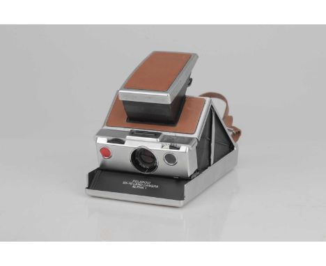 A Polaroid SX-70 Instant Camera,chrome and brown, body G, optics F-G, slight haze and dust present, untested.