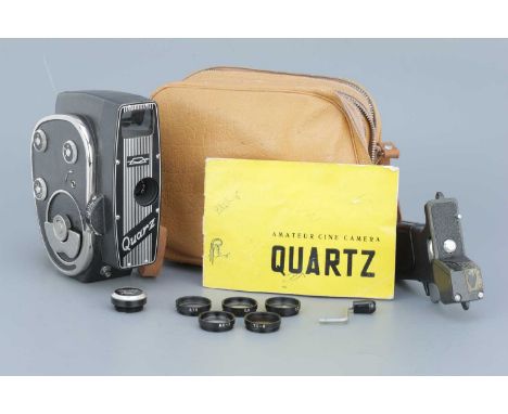 A Russian Quarz 'Quartz Amateur' 16mm Cine Camera,complete kit with filters, pistol grip, takeup spool, instructions, and mak