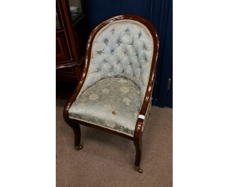 19TH CENTURY MAHOGANY HOOP BACK TUB CHAIR
with upholstered button back and seat in floral brocade, on sabre forelegs terminat