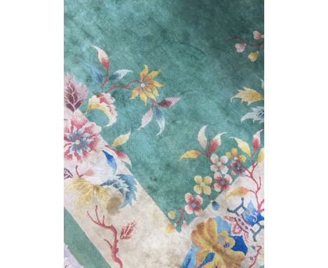 LARGE CHINESE WOOL HANDWOVEN CARPET
with Chinese design on a green ground, approximately 400cm x 300cm 