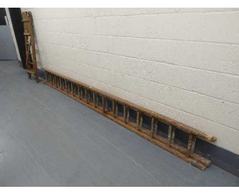 A wooden extension ladder and a wooden stepladder
