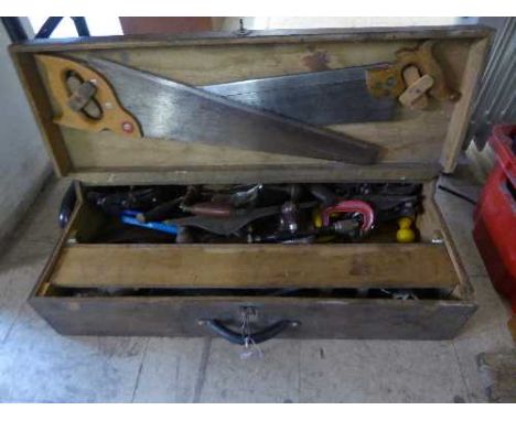A joiner's tool box containing hand tools, saws, braces, wood working planes etc
